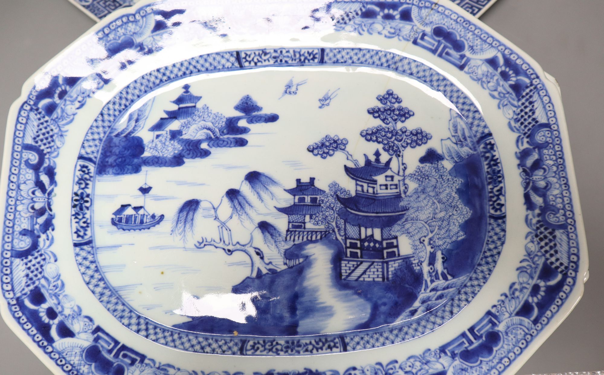 Five 18th century Chinese blue and white serving dishes, largest meat platter 44cm wide (faults)